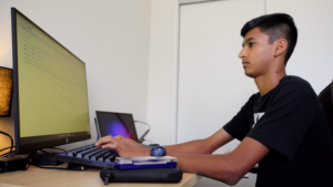 Student taking online classes on his desktop computer