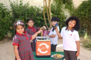 GEMS Legacy School students separating sorting recyclable waste as part of their climate education program