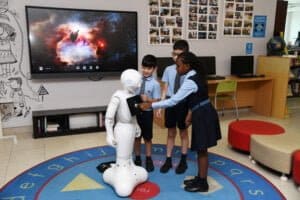 Students interacting with a robot in classroom