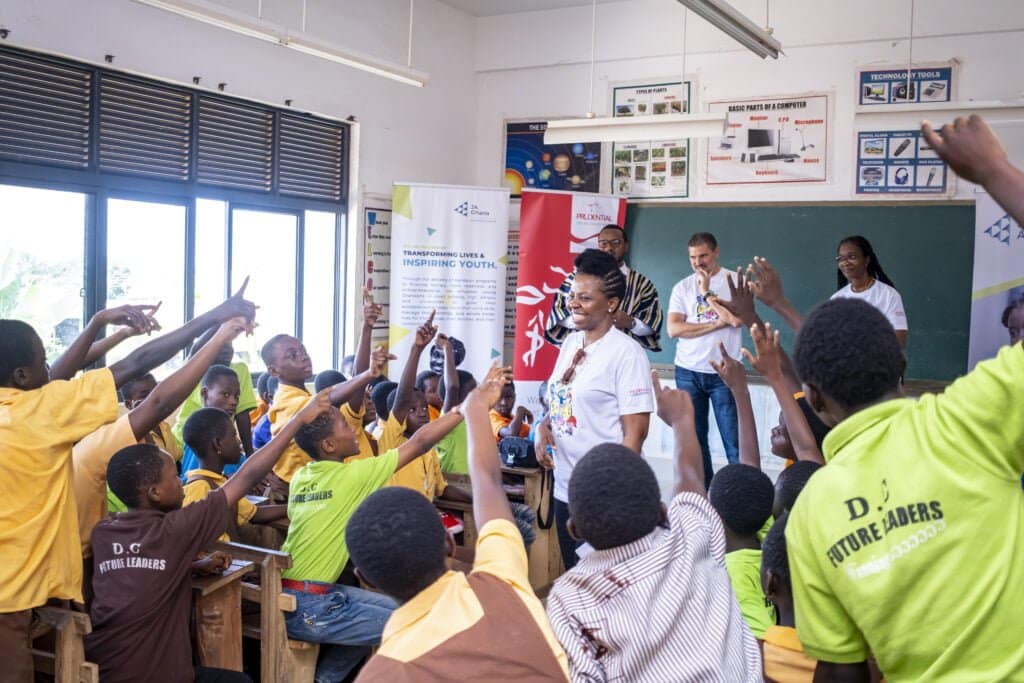 Simi Nwogugu in a classroom with students celebrating