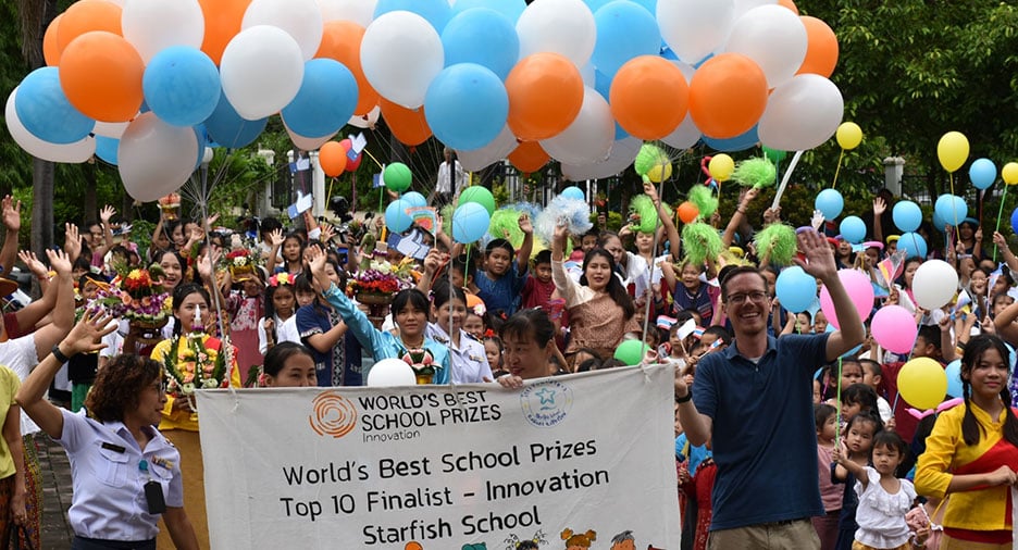 Students and staff celebrating with colorful balloons and a banner for Starfish School, a Top 10 Finalist for the World's Best School Prizes in Innovation.