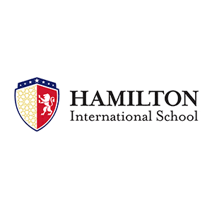 Logo of Hamilton International School featuring a red and yellow shield with a white lion and stars