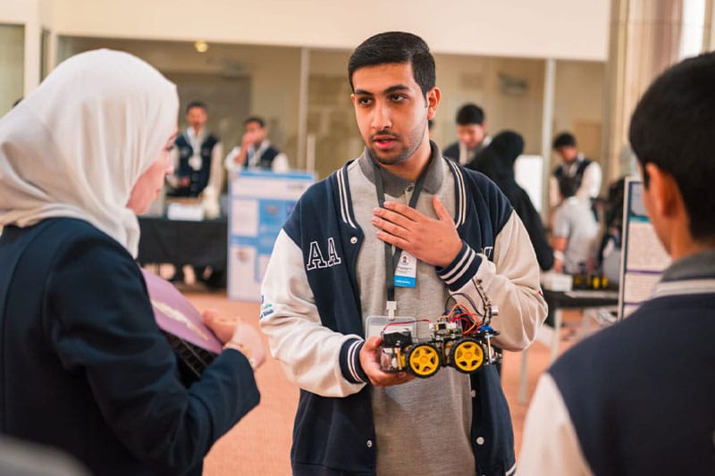 ATS UAQ student presenting a robotics project during a technology exhibition