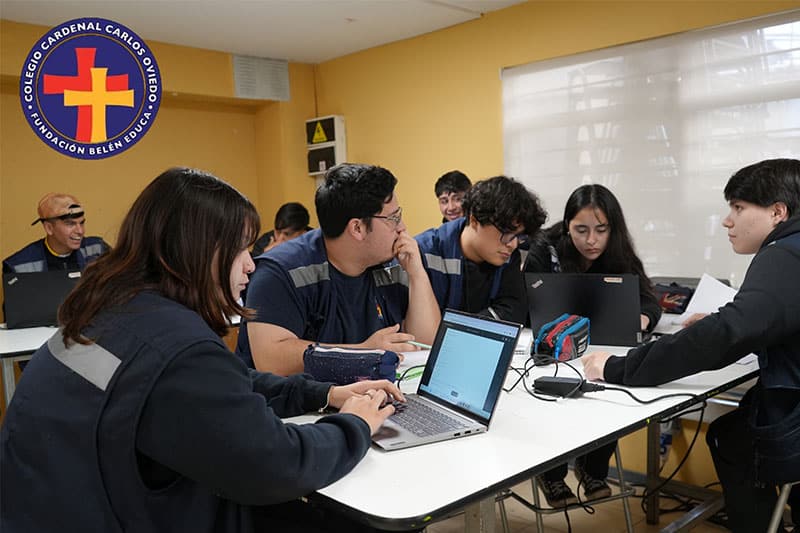High school students collaborating on laptops during a digital learning session at CBDECO