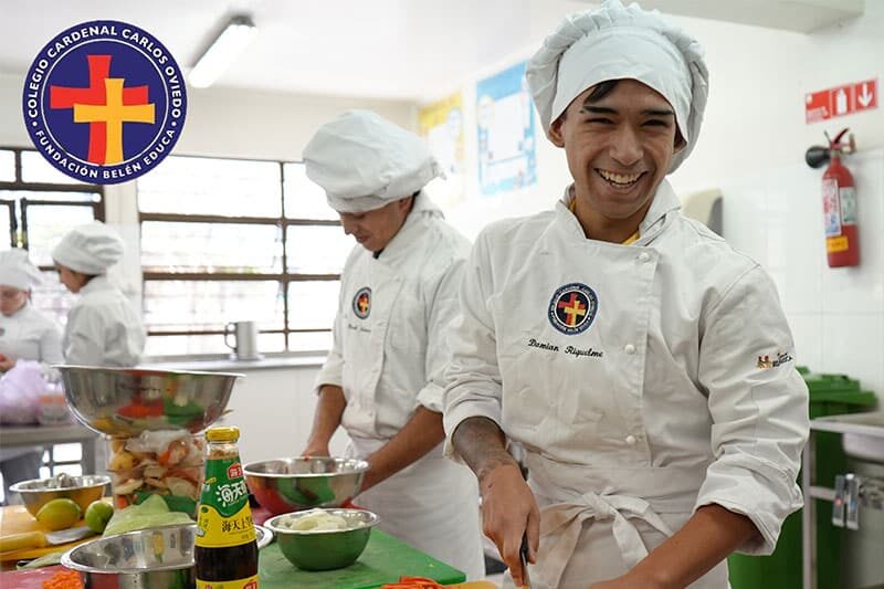 Smiling student in chef uniform preparing food during a vocational training session
