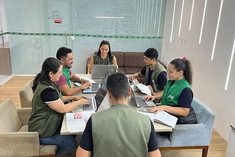 Teachers at Escola COC São Luís collaborating during a planning session on digital education strategy.