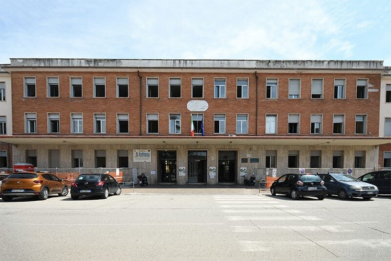 Main entrance of the technical institute building with Italian flag