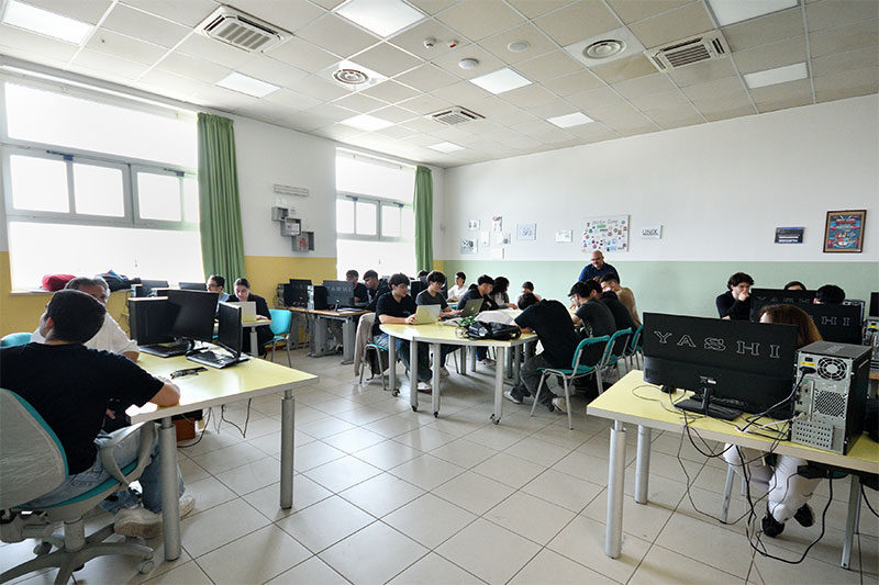 Students working on desktop computers in a modern computer lab