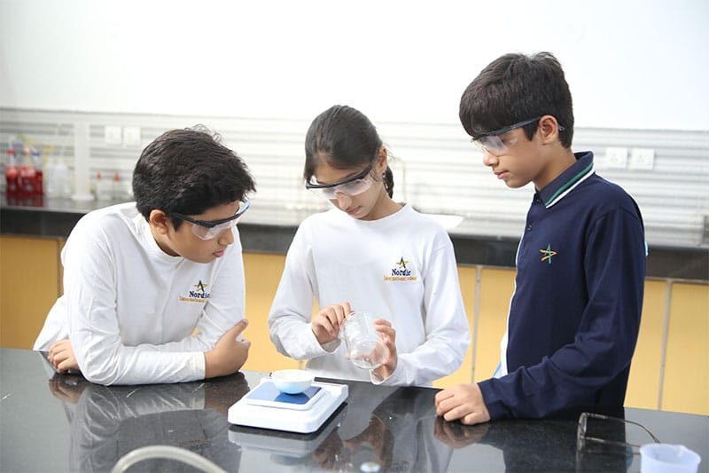 Middle school students conducting a science experiment in a laboratory
