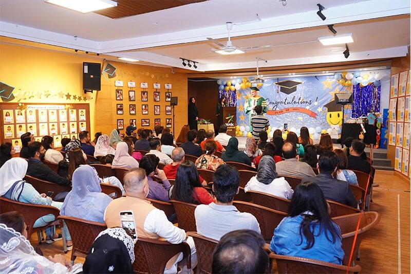Parents and students attending a graduation ceremony at the school