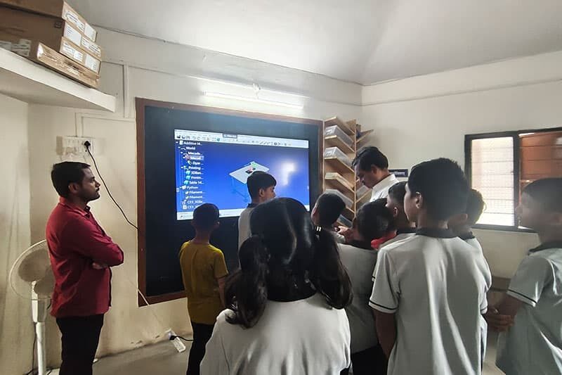 Students learning 3D modelling on a smart screen during a computer class at The School Jalindarnagar