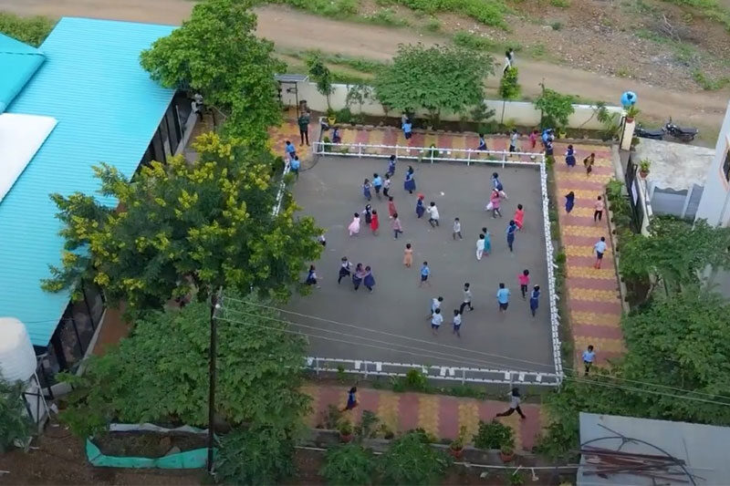 Aerial view of students playing in a courtyard during recess at The School Jalindarnagar