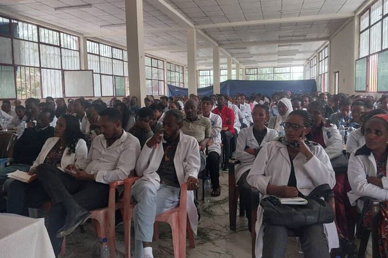 Group of teachers and staff seated indoors during a professional development session