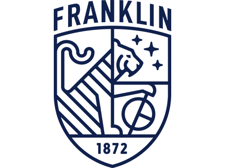 Franklin School Emblem Franklin School crest featuring a stylized lion, stars, a globe, and the year 1872 in a navy blue shield.