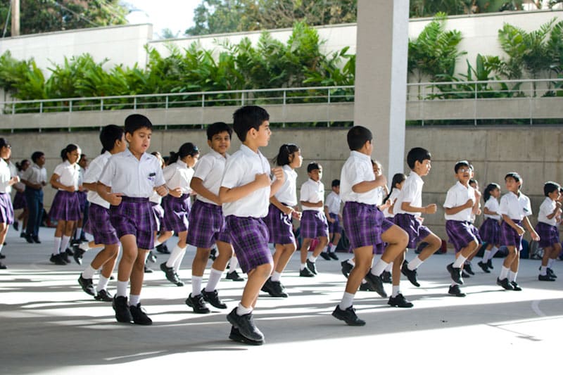 Ekya School students in uniform participating in outdoor physical activities during school hours