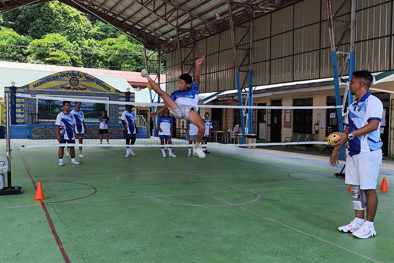 Mariveles National High School - Poblacion student performs a sepak takraw kick during sports training