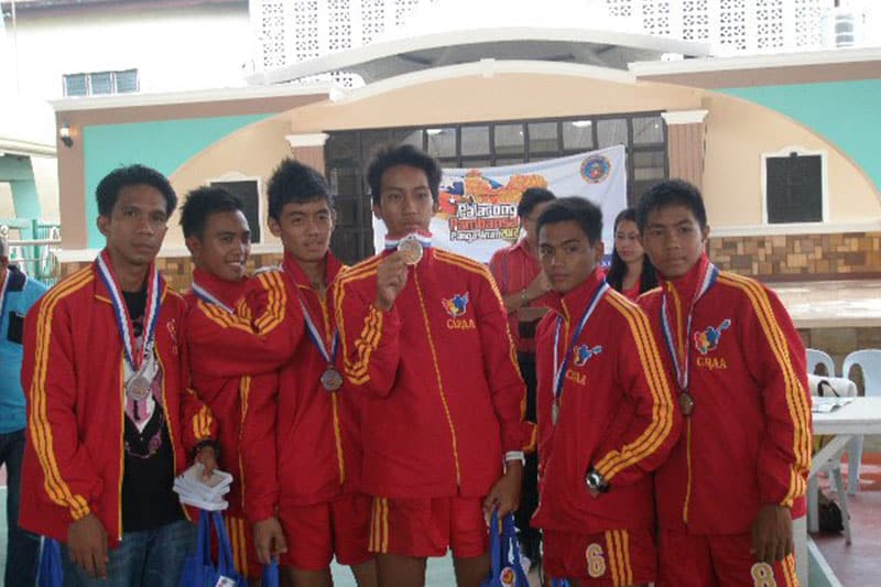 MNHS-Poblacion athletes proudly display medals after winning a sports competition
