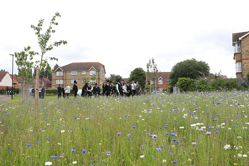 Rivers Academy West London students exploring a local wildflower garden and community orchard site