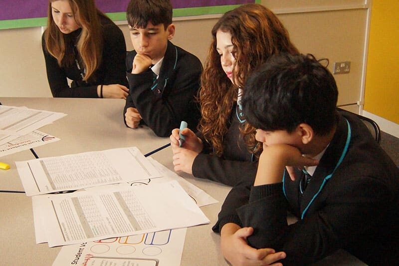 Rivers Academy students collaborating on a classroom project using real-world problem-solving
