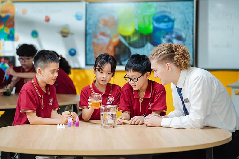 Students and teacher collaborate during a hands-on science activity in the classroom.