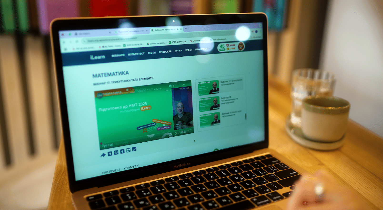 Student viewing an online mathematics lesson in Ukrainian on a laptop using the iLearn educational platform