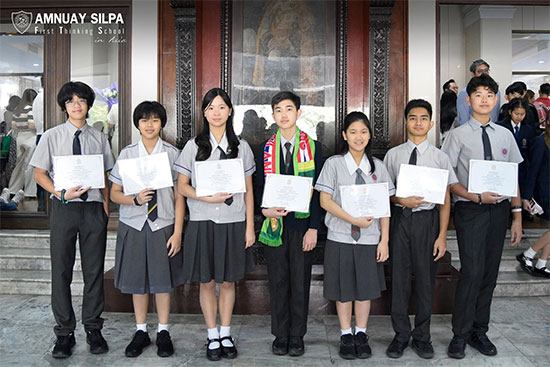 Students awarded with certificates for academic achievement Group of school students proudly holding certificates after receiving academic awards.