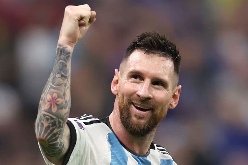 Lionel Messi celebrating with a raised fist wearing Argentina jersey