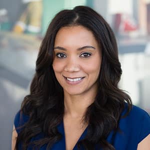 Portrait of Alison Scott, woman in a blue blouse smiling at the camera
