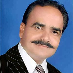 Portrait of Gajendra Rathore, man with a mustache wearing a striped suit