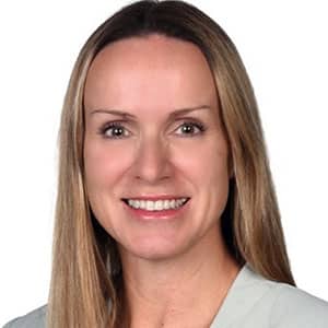 Portrait of Rebecca Coulter, woman with long hair smiling at the camera