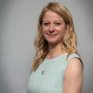 Smiling woman with light hair in a sleeveless top