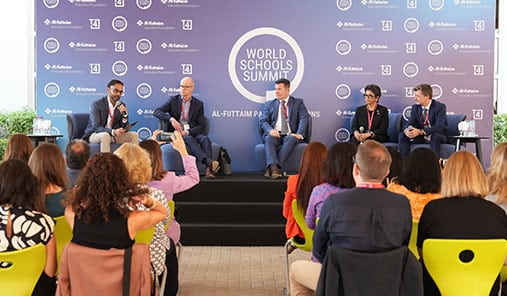 Panel discussion with education leaders speaking to an audience at the World Schools Summit.