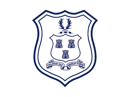 School crest with three tower symbols, laurel branch, and ribbon motto “Salvam Ole Libertate Peror”