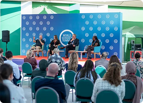 World School Summit Panel Discussion Event Panel discussion at the World School Summit with speakers on stage and audience seated