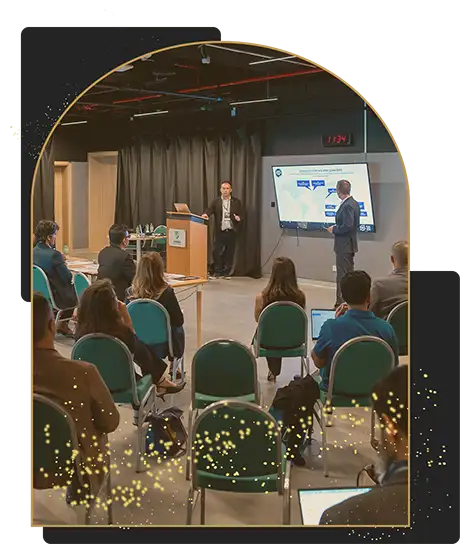 Business professionals attending a presentation in a modern conference room with two speakers and a projected screen