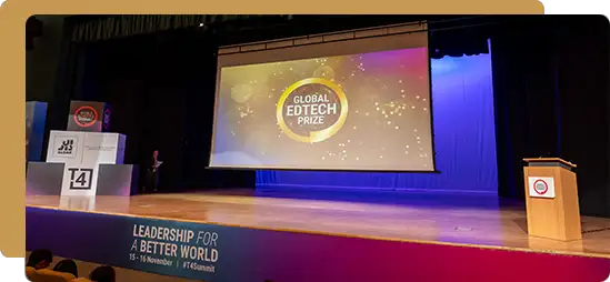 Large stage setup for the Global EdTech Prize event with projection screen, podium, and conference branding