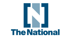 The National logo featuring a stylized blue geometric emblem above the publication name