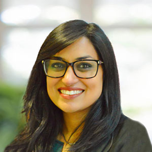 Vijita Patel Professional headshot of a smiling woman with dark hair wearing glasses and a black blazer