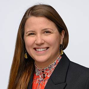 Alina Lipcan Corporate portrait of a smiling woman in professional attire