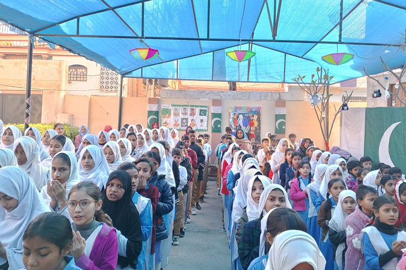 Students assembled on school grounds for a morning gathering, promoting community values and student participation.