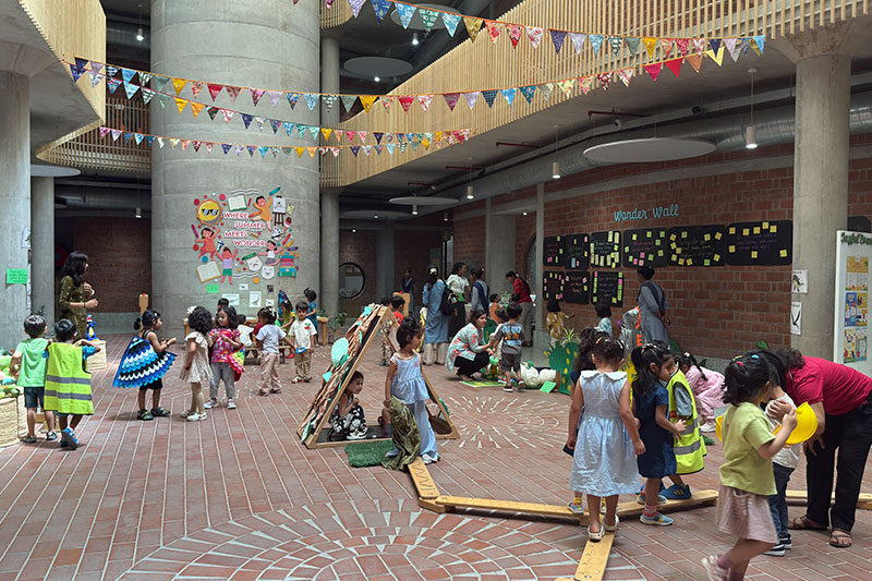 Parents and educators meeting in a collaborative community space designed to support early childhood learning and family engagement.