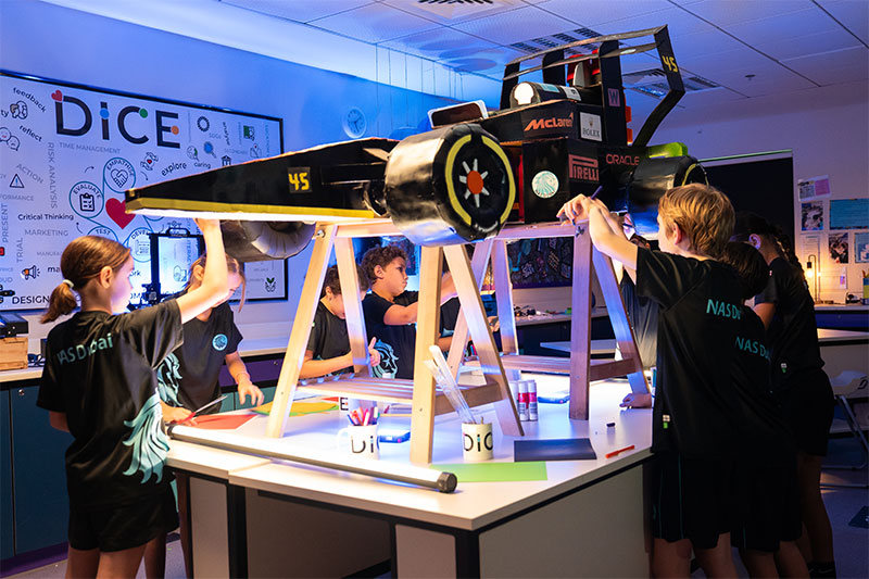 Students collaborating on a hands-on engineering and design project in a STEAM learning environment.
