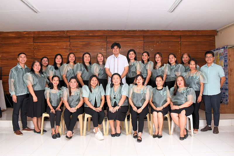 Teachers and staff members posing for a group photo at Cabog Cabog Integrated School in Balanga City Bataan