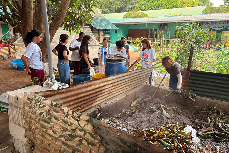 Students and volunteers participating in a school environmental clean-up and sustainability project at Cabog Cabog Integrated School