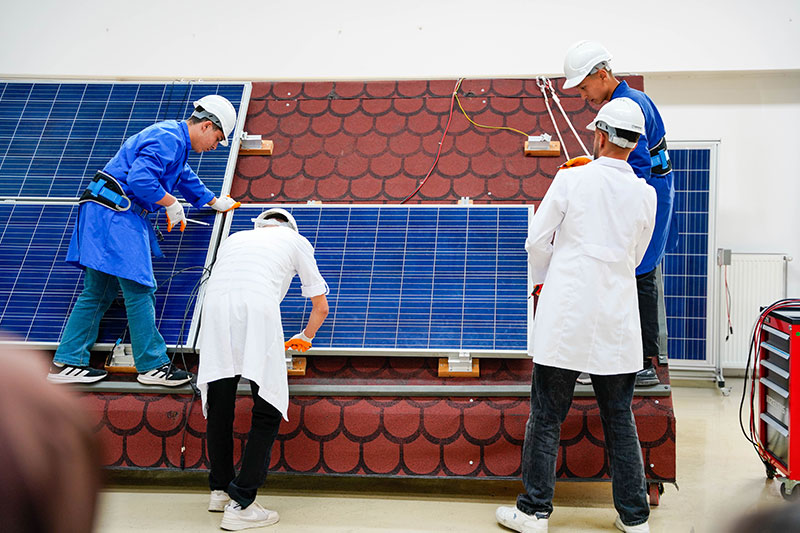 Students receiving practical training in solar panel installation and renewable energy technologies