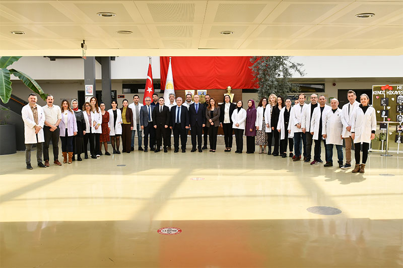 Teachers, staff and school leaders gathered for a group photograph at a modern educational institution