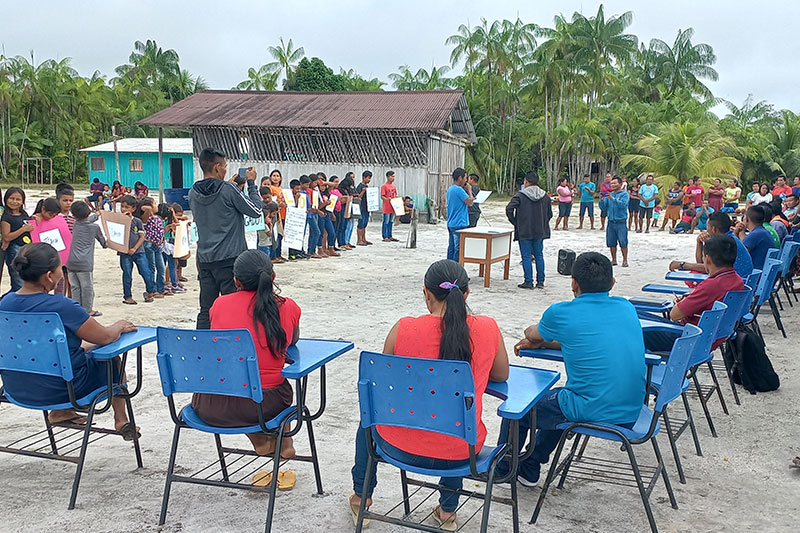 Learners and community members participating in an outdoor educational forum focused on leadership, dialogue, and collective decision-making.