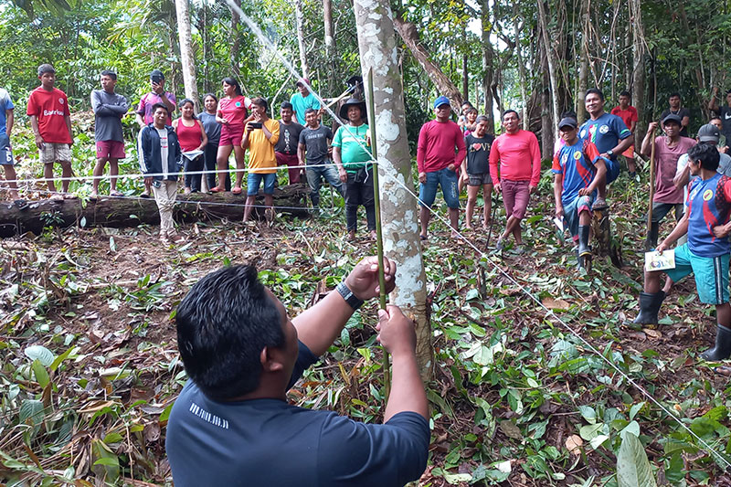 Community members participating in a practical outdoor learning activity focused on environmental awareness, agriculture, and land stewardship.