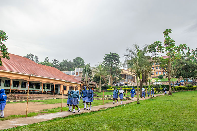 Students walking through the landscaped grounds of St Kizito High School Nansana during the school day