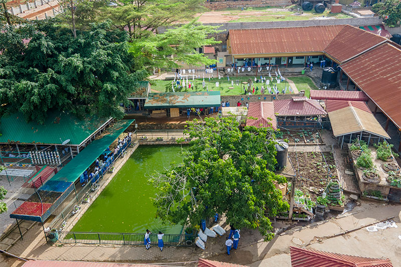 Aerial view of St Kizito High School Nansana featuring agricultural projects, fish ponds and learning facilities